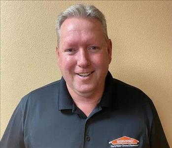 White male in a black SERVPRO polo