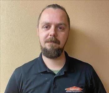 male in a black SERVPRO® polo