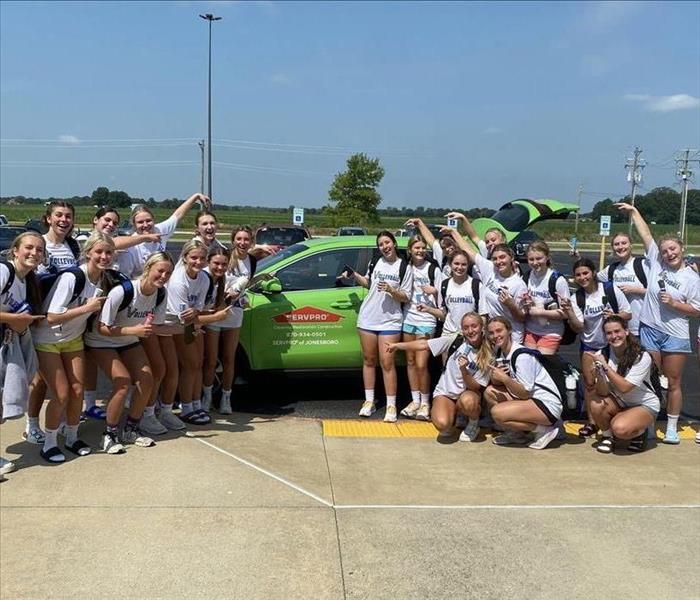 Vally View volleyball team posing with ice cream in front of SERVPRO truck 