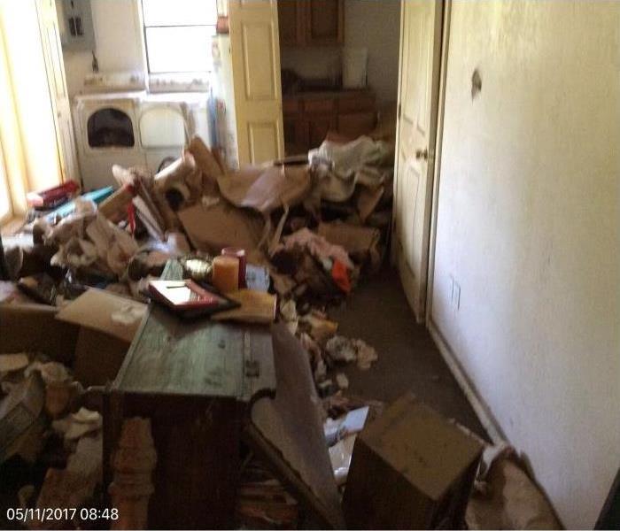 a room full of items in no paticular order inside a residential home due to a flood