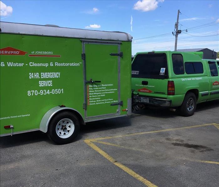 SERVPRO truck with trailor on the back to carry equipment, advertising is on the side of the trailer and truck