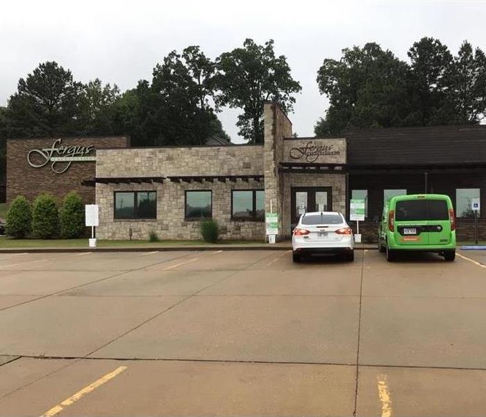 Outside view of Fergus Orthodontist with SERVPRO truck in the parking lot with a white vehicle next to it
