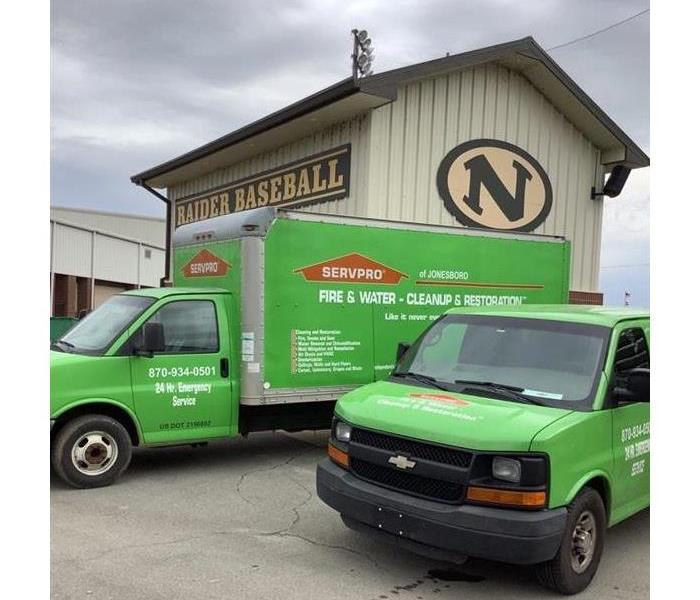 SERVPRO truck and van in front of Nettleton High School baseball concession stand